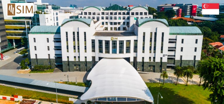 Aerial view of the singapore institute of management campus with white buildings and a distinctive roof design, surrounded by greenery.