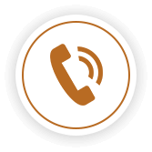 A circular white icon with a gold border, featuring a golden telephone handset symbol.
