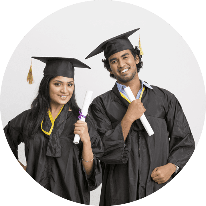 Two smiling graduates, a man and a woman, wearing caps and gowns, holding diplomas against a grey background.