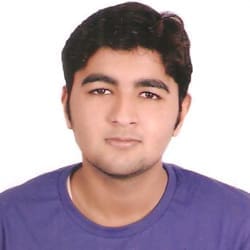 Portrait of a young man in a purple shirt, looking at the camera with a neutral expression, set against a plain white background.