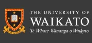 Logo of the University of Waikato, featuring a shield with a book emblem, flanked by Māori carvings, with the name in English and Māori.